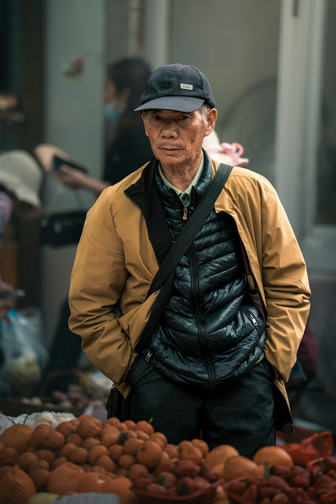 Portrait of an older Chilean street vendor smiling behind his fruit stall