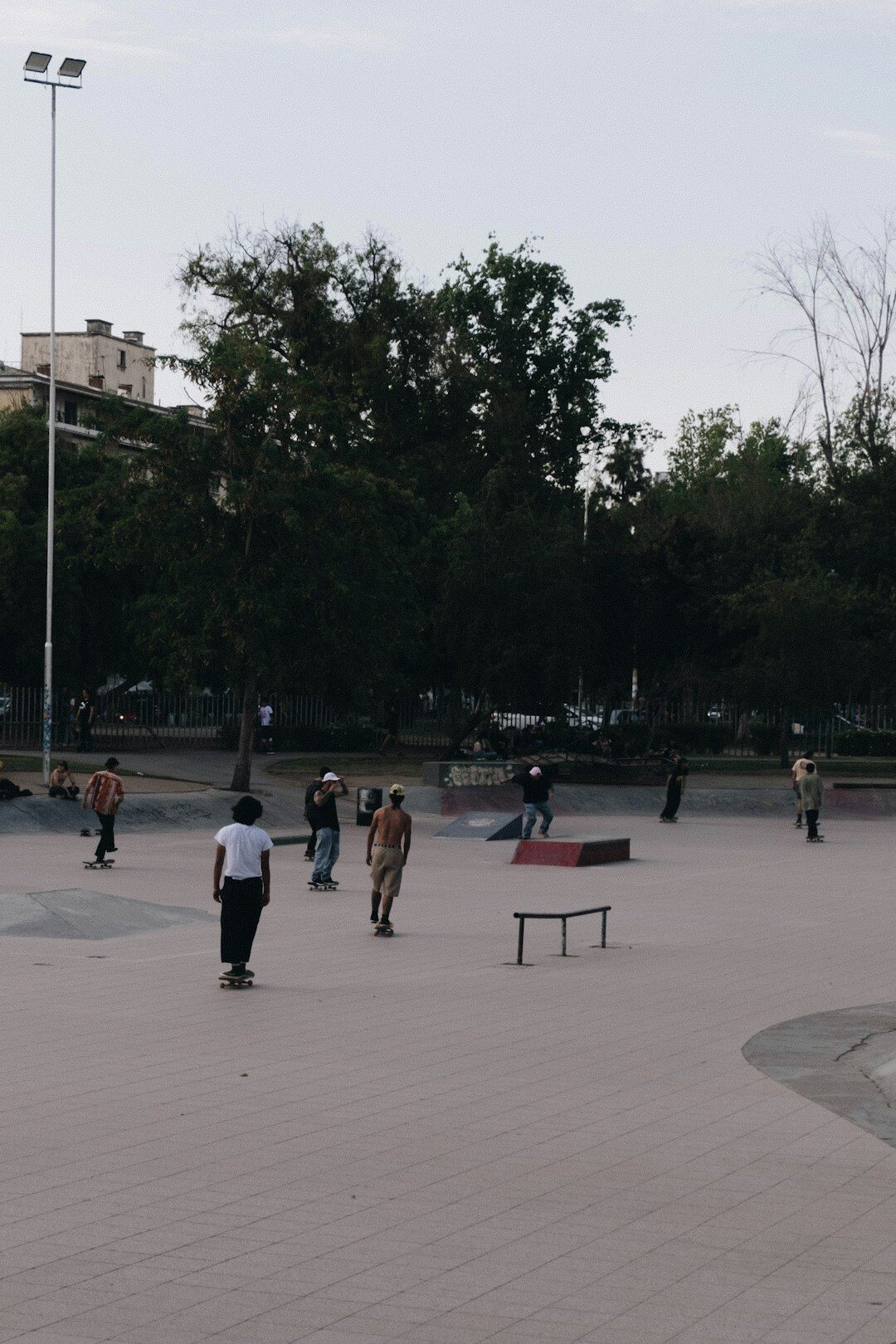 People sitting on a public square bench sharing conversation in a Chilean city
