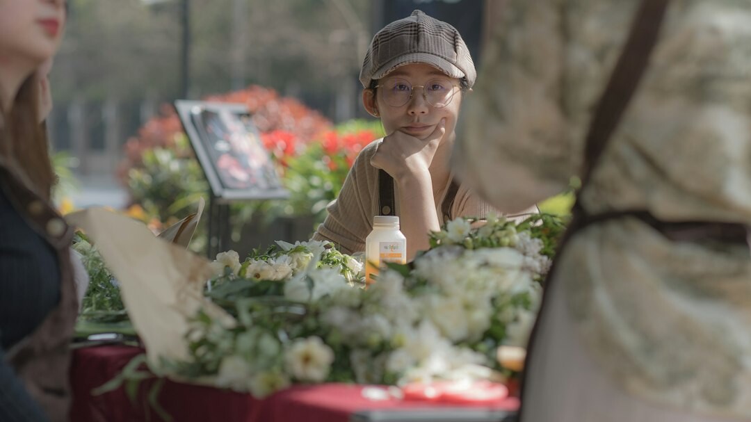 elderly woman selling flowers